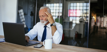 Struggling to Spend Your Retirement Savings? Here's What to Do.: https://g.foolcdn.com/editorial/images/847317/older-man-laptop-serious-gettyimages-1062936696.jpg