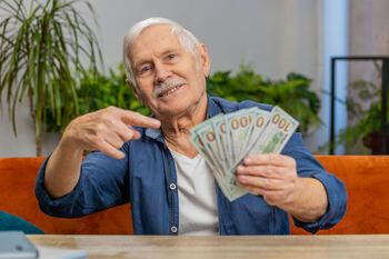 3 Dividend Stocks to Buy to Create the Gift That Keeps on Giving: https://g.foolcdn.com/editorial/images/840945/older-investor-holding-several-hundred-dollar-bills.jpg