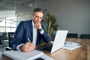 These 2 Social Security Changes in 2026 Could Deal Working Americans a Major Blow: https://g.foolcdn.com/editorial/images/847982/man-40s-biz-suit-desk-taking-notes-gettyimages-1552851631.jpg