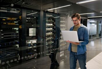 Can Rigetti Computing Stock Turn a $10,000 Investment Into $1 Million?: https://g.foolcdn.com/editorial/images/849339/peson-using-a-laptop-standing-in-a-data-center.jpg