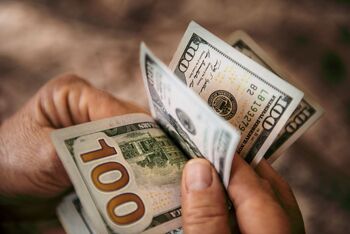 Want Over $2,000 in Dividends Each Year? Invest $12,000 Each Into These 3 Stocks: https://g.foolcdn.com/editorial/images/849342/a-person-flipping-through-dollar-bills.jpg