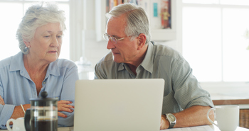 Scared to Tap Your Retirement Savings? 3 Things to Do.: https://g.foolcdn.com/editorial/images/850354/senior-couple-laptop-serious-gettyimages-1180121935.jpg