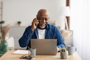 Is This the Perfect Age to Start Collecting Social Security?: https://g.foolcdn.com/editorial/images/850629/person-talking-on-the-phone-and-looking-at-a-laptop.jpg