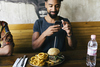 Why Chipotle Stock Collapsed Last Year: https://g.foolcdn.com/editorial/images/851517/guy-taking-photo-of-burger.jpg