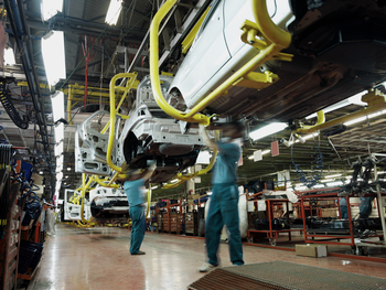 Where Will Rivian Be in 1 Year?: https://g.foolcdn.com/editorial/images/851285/22_08_01-people-working-on-an-auto-assembly-line-auto-mechanic-industry-building-_mf-dload.jpg