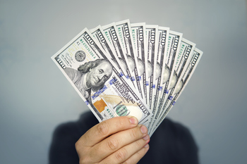 2 of My Favorite Dividend Stocks for the Next 10 Years: https://g.foolcdn.com/editorial/images/840464/holding-money-2022b.jpg
