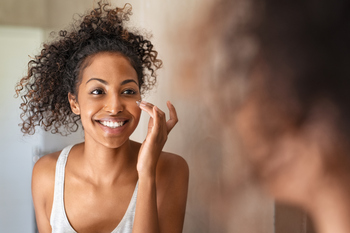 Here's Why I May Add e.l.f. Beauty Stock to My Portfolio: https://g.foolcdn.com/editorial/images/852198/young-woman-standing-in-front-of-mirror-applying-face-cream.jpg