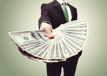 Prediction: These 2 Top Stocks Will Be the Largest REIT Dividend Payers in 2026: https://g.foolcdn.com/editorial/images/851152/a-person-in-a-suit-holding-out-a-fan-of-cash.jpg