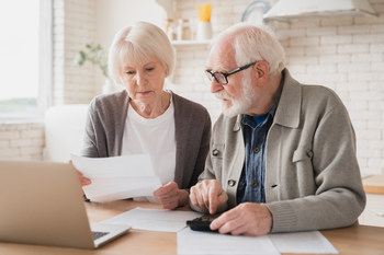 The Sneaky Reason You Might Fall Behind on Retirement Savings: https://g.foolcdn.com/editorial/images/852265/senior-couple-laptop-documents-gettyimages-1367867682.jpg