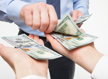 These 2 Financial Stocks Just Declared Dividend Raises: https://g.foolcdn.com/editorial/images/852909/person-placing-money-in-both-hands-of-another-person.jpg