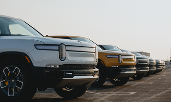 Is Rivian Stock a Buy in 2026?​: https://g.foolcdn.com/editorial/images/850380/line-of-_rivian-trucks-in-parking-lot_rivian_-3.jpg