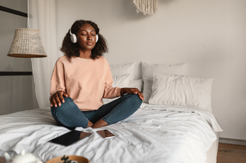 2 Cathie Wood Stocks to Buy on the Dip: https://g.foolcdn.com/editorial/images/852977/person-sitting-on-a-bed-wearing-headphones.jpg
