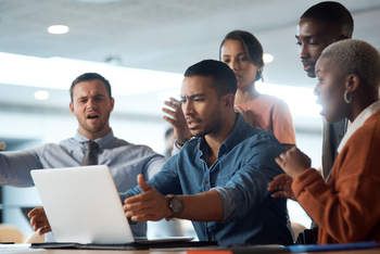 The Biggest Obstacle to Netflix Acquiring Warner Bros. Isn't Paramount Skydance. It's This.: https://g.foolcdn.com/editorial/images/853990/frustrated-people-looking-at-a-laptop.jpg