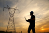 2 Utility Stocks to Buy in February: https://g.foolcdn.com/editorial/images/853776/a-person-wearing-a-hardhat-and-holding-a-laptop-near-a-power-line.jpg
