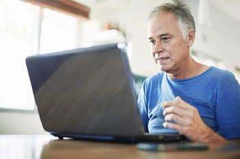 A New Rule Lets You Tap Your 401(k) Early Penalty-Free. But Don't Get Too Excited About It.: https://g.foolcdn.com/editorial/images/854118/man-50s-laptop-gettyimages-1371314132.jpg