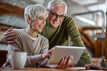 2 High-Yielding Stocks That Retirees Will Love: https://g.foolcdn.com/editorial/images/854001/a-couple-looking-at-a-tablet.jpg