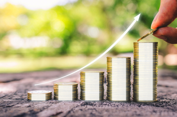 2 Dividend Stocks to Hold for the Next 5 Years: https://g.foolcdn.com/editorial/images/853853/a-person-putting-another-coin-on-a-growing-stack.jpg