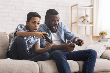 Did Nintendo Just Say Checkmate to Disney?: https://g.foolcdn.com/editorial/images/864561/father-and-kid-playing-video-games.jpg
