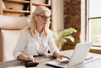 This Is the Main Thing to Look for When SoFi Reports Earnings on April 29, and It's Not What You Think: https://g.foolcdn.com/editorial/images/865680/a-person-sitting-with-a-computer-and-a-calculator.jpg