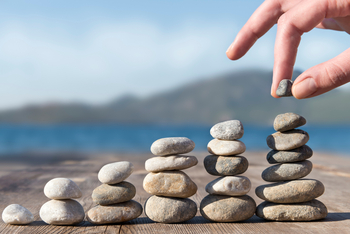 Meet the 5.7%-Yielding Value Stock That's on Track to Become a Dividend King Next Year: https://g.foolcdn.com/editorial/images/868761/a-person-stacking-stones-in-increasingly-taller-towers-on-a-dock-by-a-body-of-water-illustrating-the-concept-of-compound-passive-income-from-dividend-stocks.jpg