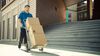 Is UPS Stock a Bad-News Buy?: https://g.foolcdn.com/editorial/images/869377/a-delivery-person-in-a-blue-uniform-pushes-a-hand-truck-loaded-with-cardboard-boxes-past-a-modern-building.jpg