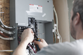3 Electrical Infrastructure Stocks With Shockingly Strong Returns: https://g.foolcdn.com/editorial/images/868796/electrician-fixing-wiring-fuse-box.jpg
