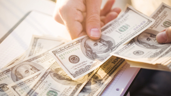 Could Buying Energy Transfer Stock Today Set You Up for Life in Passive Income?: https://g.foolcdn.com/editorial/images/850453/a-hand-counting-100-bills.jpg