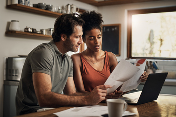 Should You Choose a Roth 401(k) Over a 401(k) for Retirement Savings?: https://g.foolcdn.com/editorial/images/853916/couple-looking-at-paperwork-together.jpg