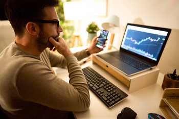 Is XRP (Ripple) on the Way to $1 in 2026? Here's Why It Looks Increasingly Likely.: https://g.foolcdn.com/editorial/images/855003/an-investor-looking-at-a-chart-on-their-computer-screen-while-holding-a-smartphone.jpg