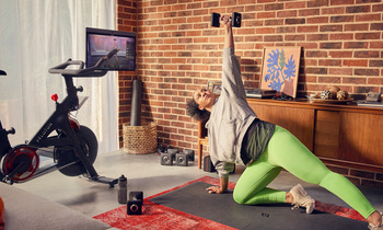 Is It Time to Buy Peloton Stock? Here's the Good News and the Bad News: https://g.foolcdn.com/editorial/images/855351/a-person-working-out-with-free-weights-while-watching-a-class-through-the-screen-on-their-peloton-bike.jpg