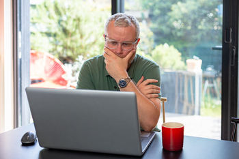 3 Reasons Not to Max Out Your 401(k) This Year: https://g.foolcdn.com/editorial/images/855103/man-40s-laptop-by-window-gettyimages-1403978354.jpg