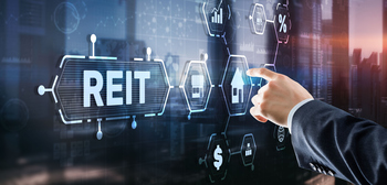 3 Stocks That Cut You a Check Each Month: https://g.foolcdn.com/editorial/images/855118/a-hand-pointing-at-a-digital-board-that-says-reit.jpg
