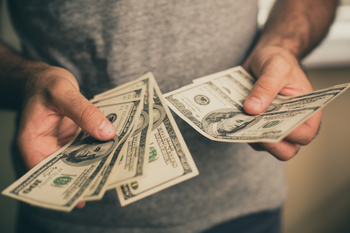 Want Decades of Passive Income? Buy This ETF and Hold It Forever: https://g.foolcdn.com/editorial/images/856488/counting-money-dollar-bills1.jpg