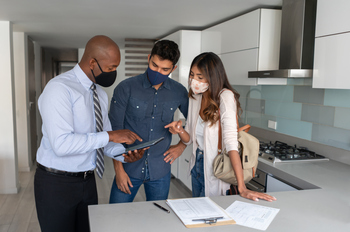 Why UWM Holdings Stock Sank by 10% in February: https://g.foolcdn.com/editorial/images/859840/two-people-conferring-with-another-person-in-the-kitchen-of-a-home.jpg