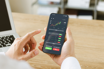 2 Cathie Wood Stocks to Buy and Hold for 10 Years: https://g.foolcdn.com/editorial/images/859215/person-making-a-trade-on-a-stock-trading-app.jpg